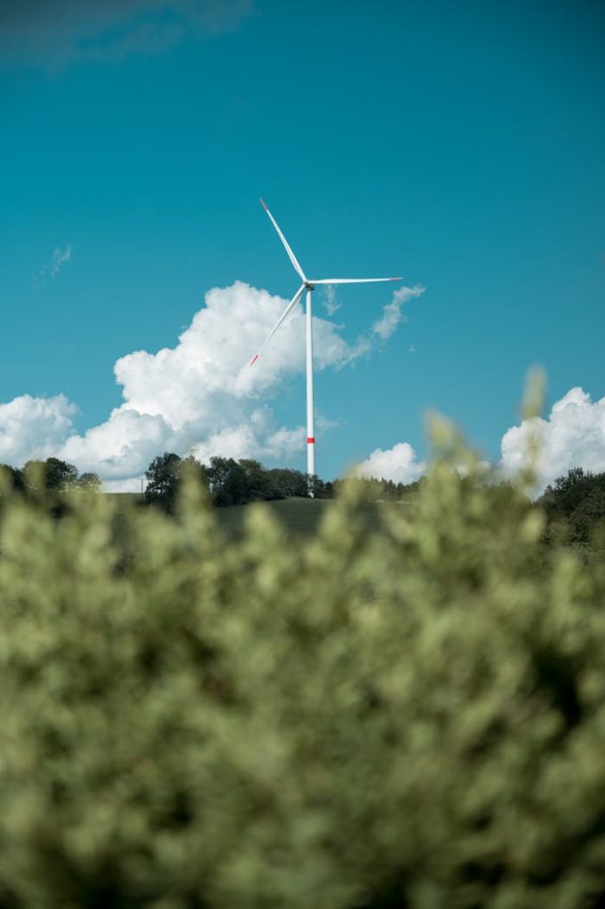 white-wind-turbine-through-green-grass-3315512 Wind turbine against a blue sky and clouds in Zlatá Olešnice, Czechia.
